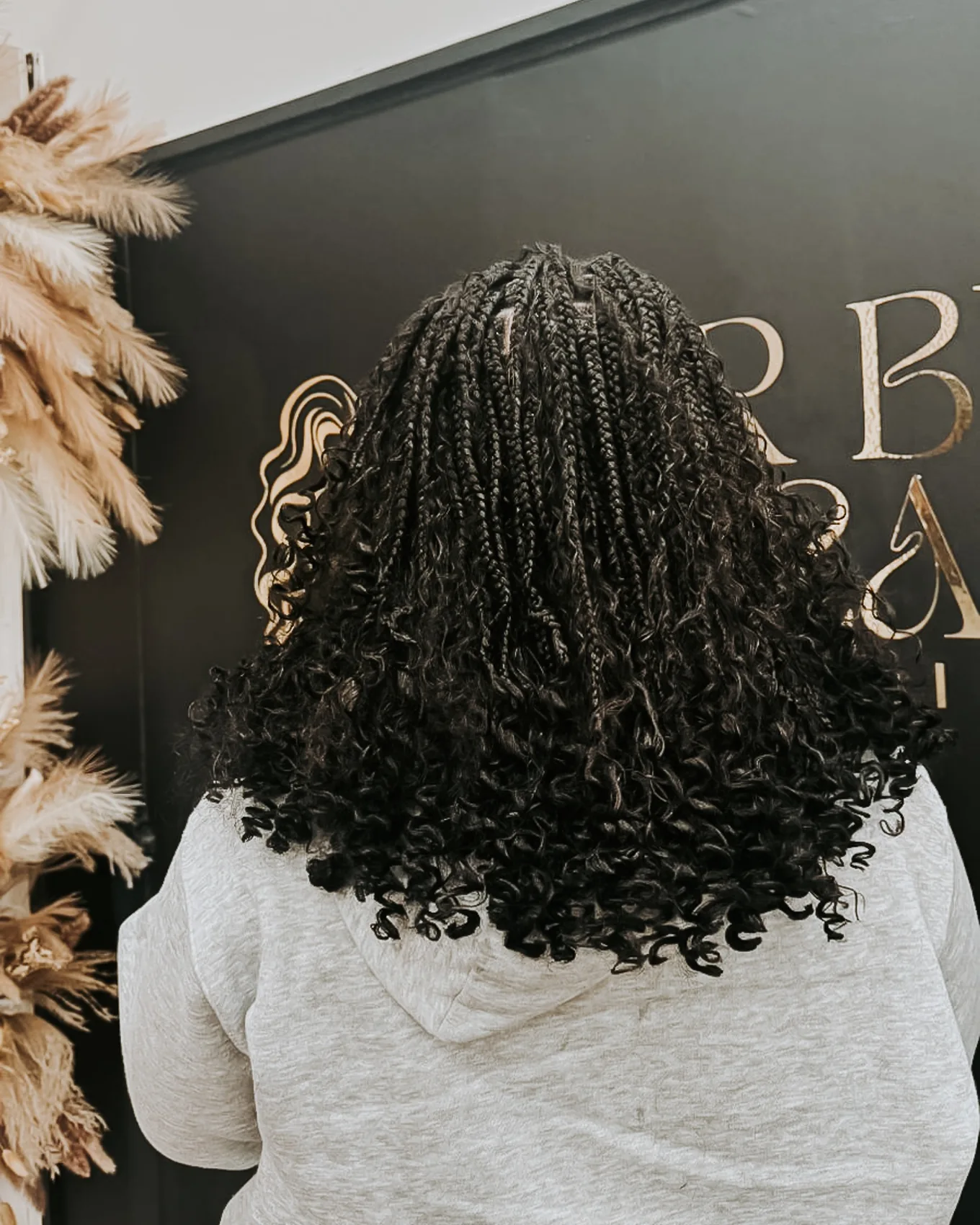 Detailed back view of black curly braids