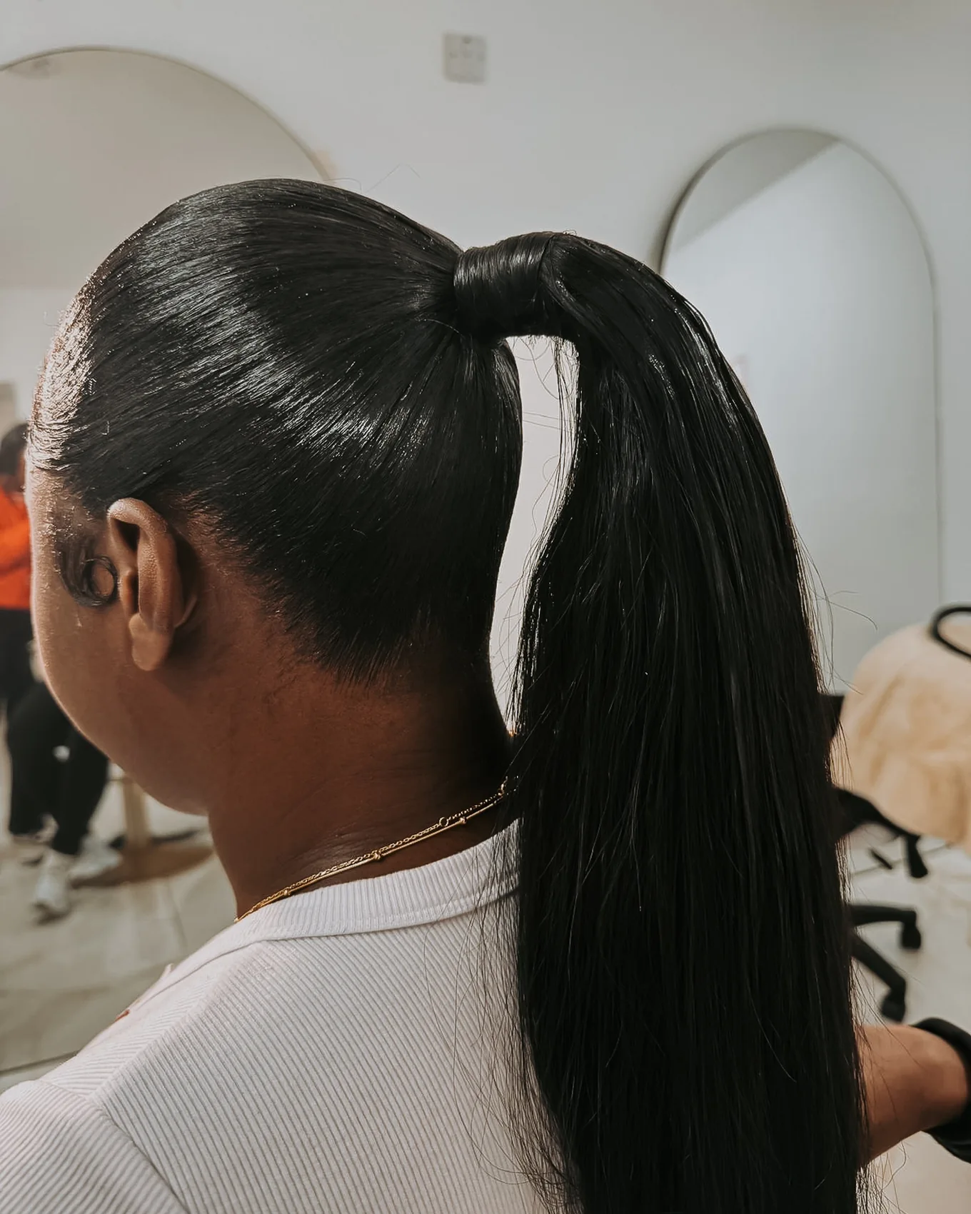 Glossy high ponytail hairstyle viewed from the back