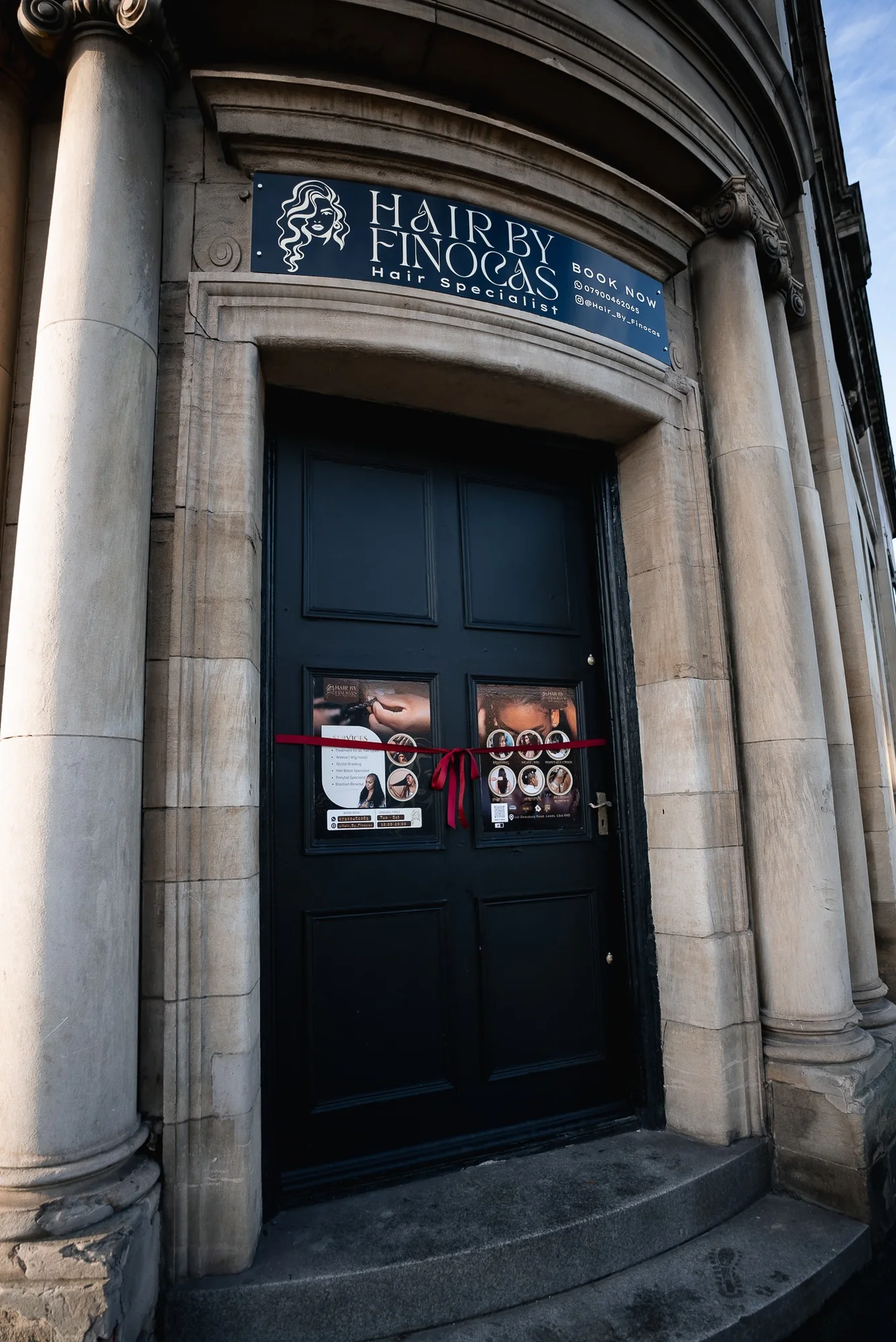 Hair by Finocas entrance beneath the salon sign